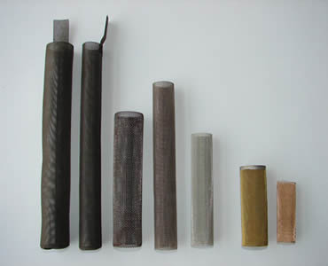 Seven different kinds and materials of cylindrical filters stand on the white background.